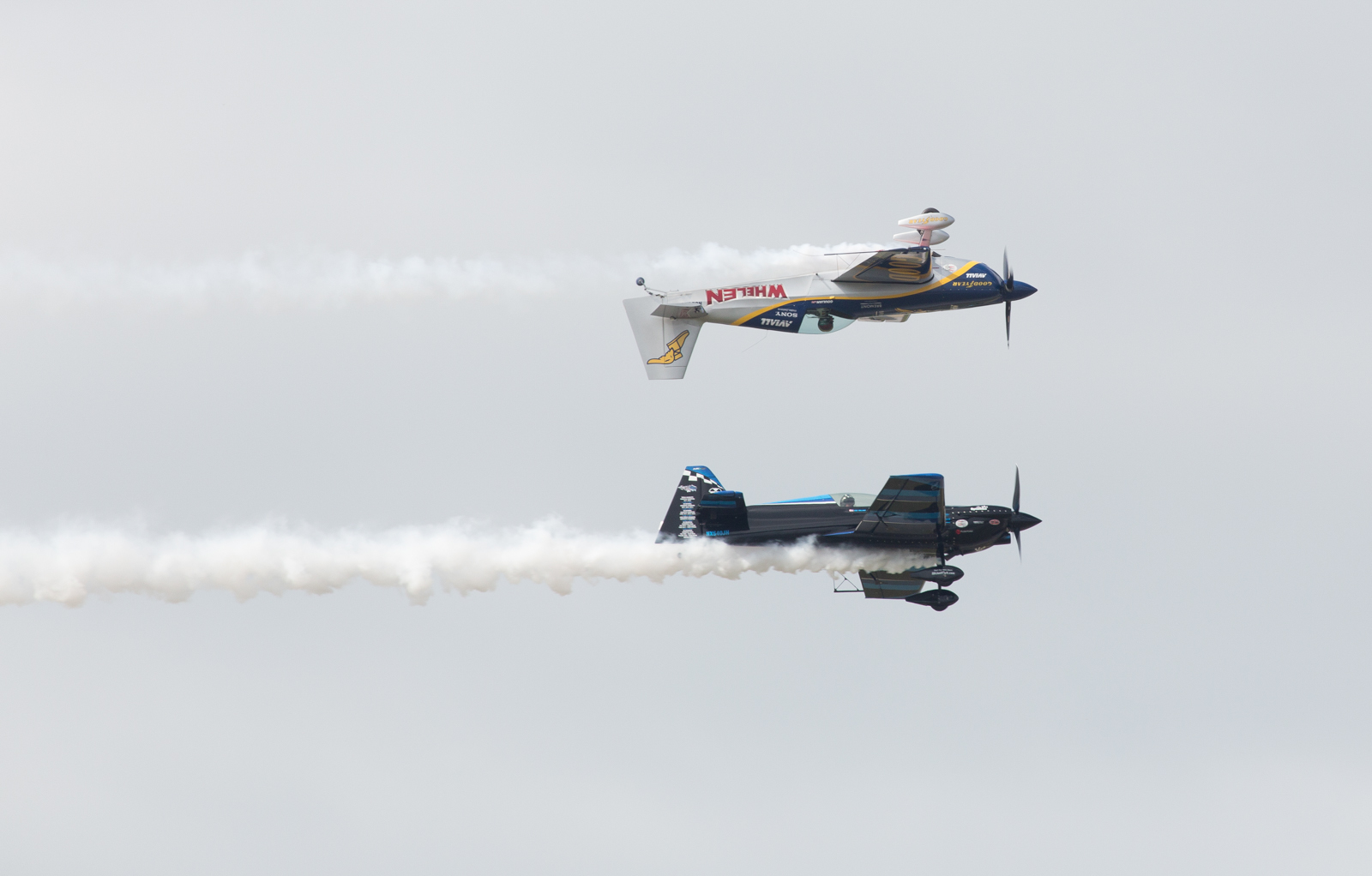 Mike Goulian in an Extra 330SC and Rob Holland in MXS-RHa in a Calypso Pass at Macdill Airfest 2014