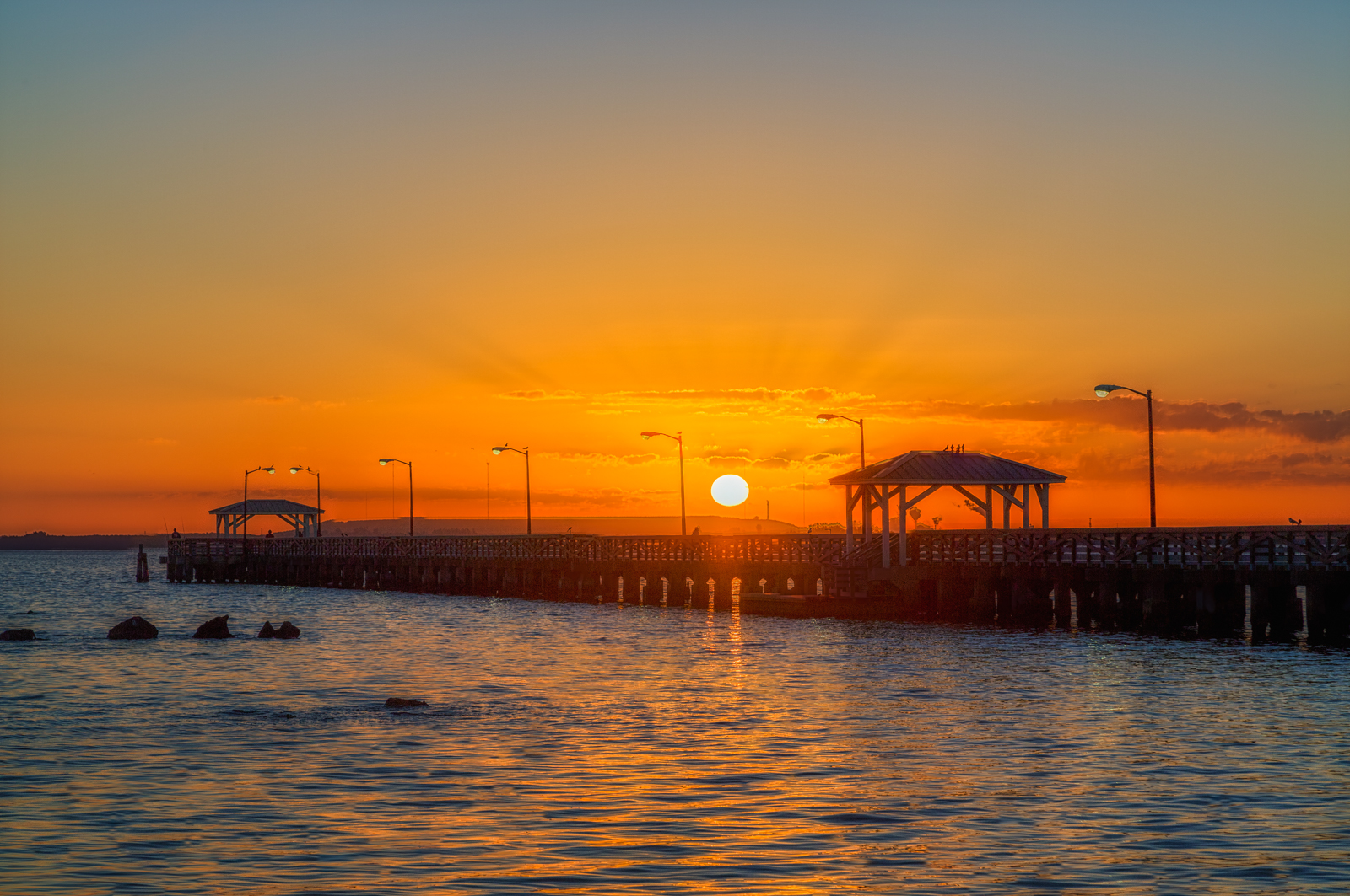 Sun fully risen over Ballast Point Park Pier, Tampa, Florida