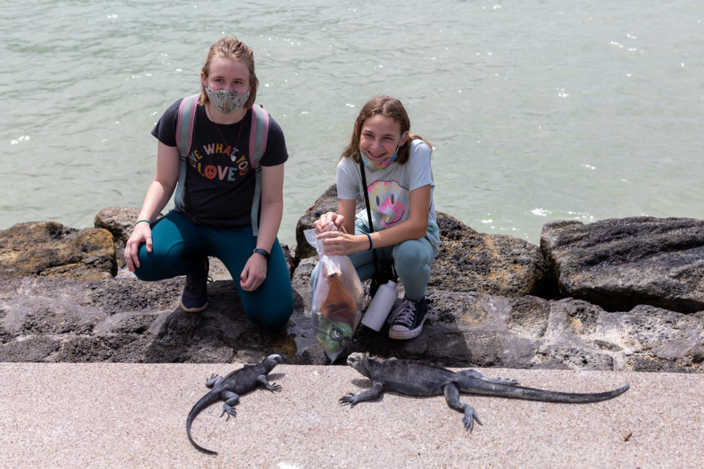 Girls with Marine Iguanas