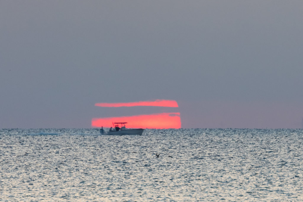 Boat in front of Rising Sun